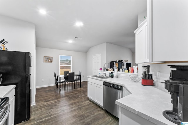 kitchen with stainless steel appliances, vaulted ceiling, dark wood-type flooring, sink, and white cabinets