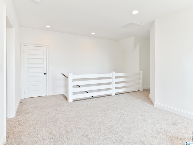 empty room with light colored carpet