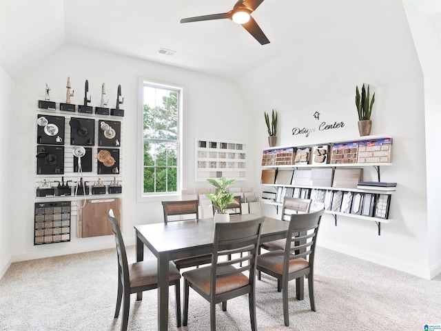 dining room featuring light colored carpet, ceiling fan, and lofted ceiling