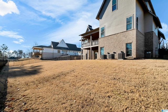 rear view of house with a balcony and cooling unit