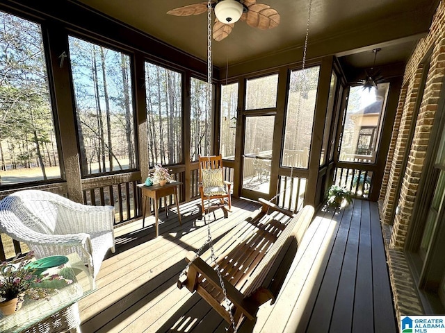 sunroom / solarium featuring ceiling fan