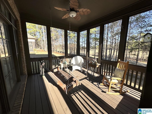 sunroom / solarium featuring ceiling fan