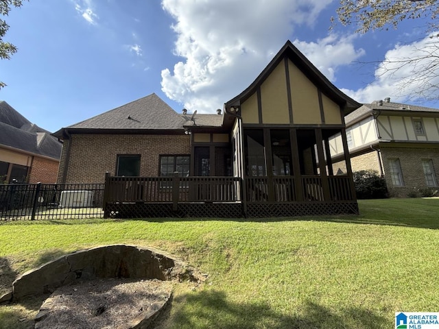 back of house with a sunroom and a yard