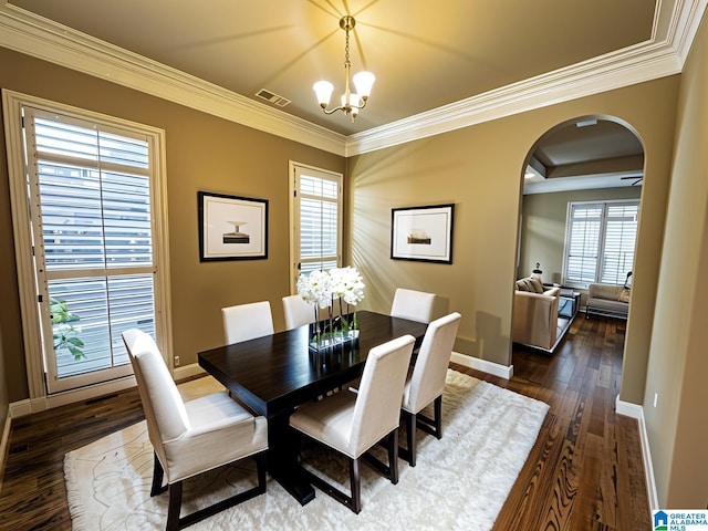 dining room with a notable chandelier, dark hardwood / wood-style flooring, and crown molding