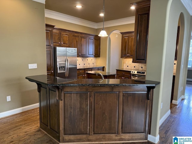 kitchen featuring backsplash, dark brown cabinets, dark hardwood / wood-style floors, and stainless steel refrigerator with ice dispenser