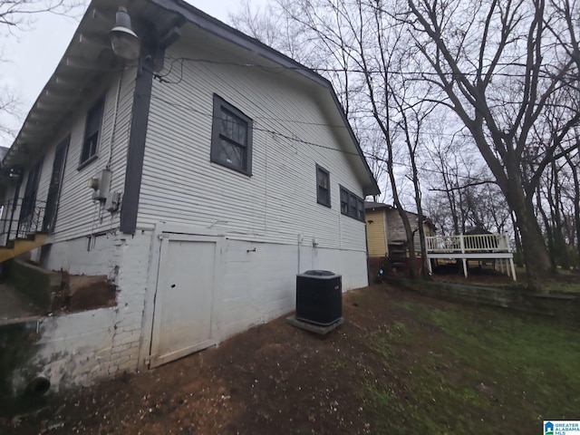 view of side of home featuring cooling unit