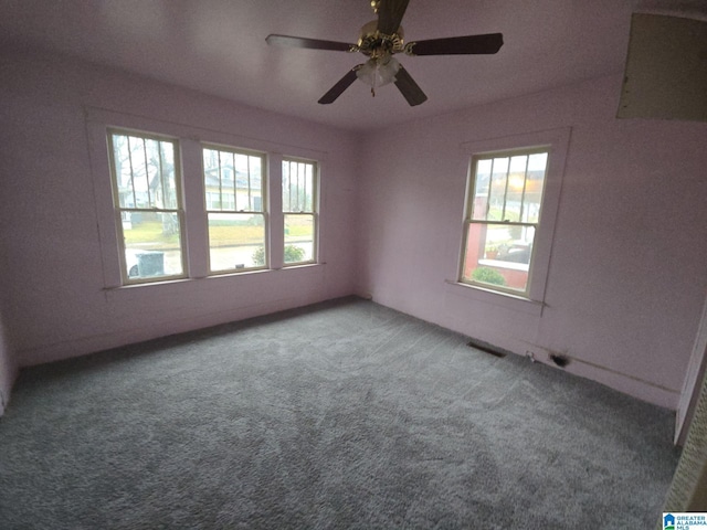 carpeted spare room with ceiling fan