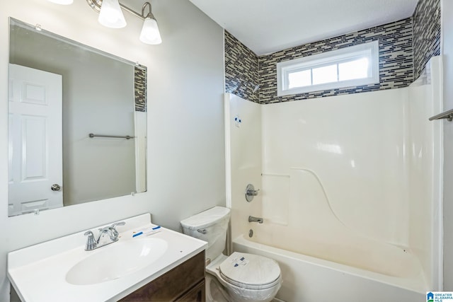 full bathroom with tiled shower / bath combo, toilet, and vanity