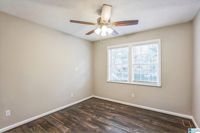 empty room with ceiling fan, dark hardwood / wood-style floors, and a textured ceiling