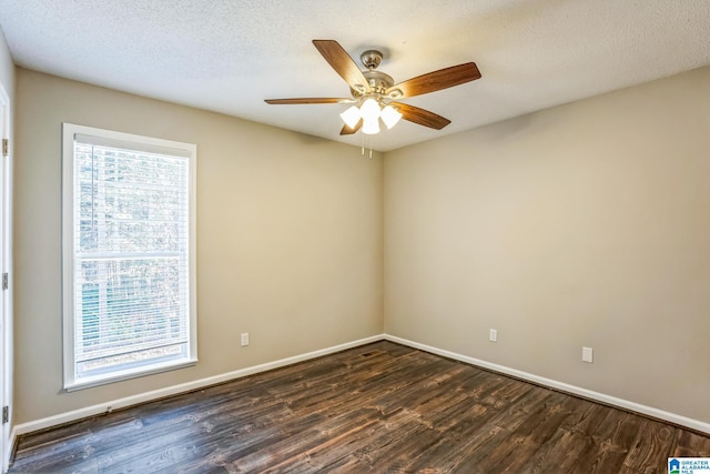 unfurnished room with a textured ceiling, ceiling fan, and dark wood-type flooring