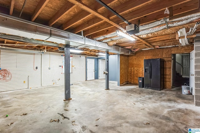 interior space with black fridge and a garage door opener