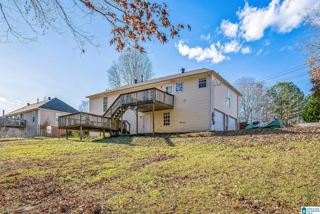 rear view of house featuring a yard, a garage, and a wooden deck