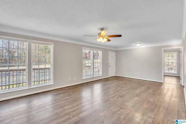 unfurnished room featuring hardwood / wood-style flooring, ceiling fan, a healthy amount of sunlight, and crown molding