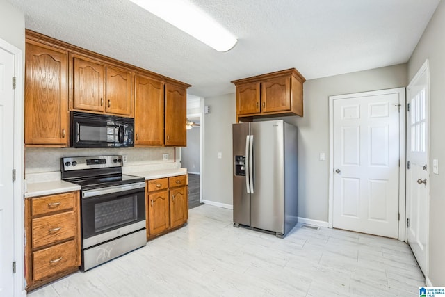 kitchen featuring appliances with stainless steel finishes and backsplash