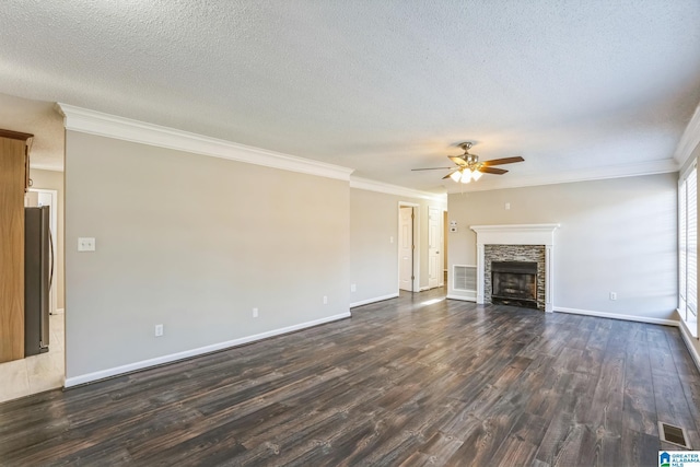 unfurnished living room with ceiling fan, dark hardwood / wood-style flooring, crown molding, a textured ceiling, and a fireplace