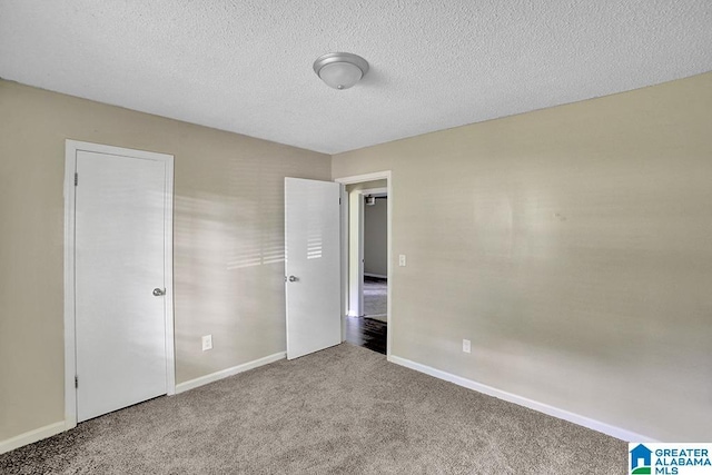 unfurnished bedroom featuring carpet flooring and a textured ceiling