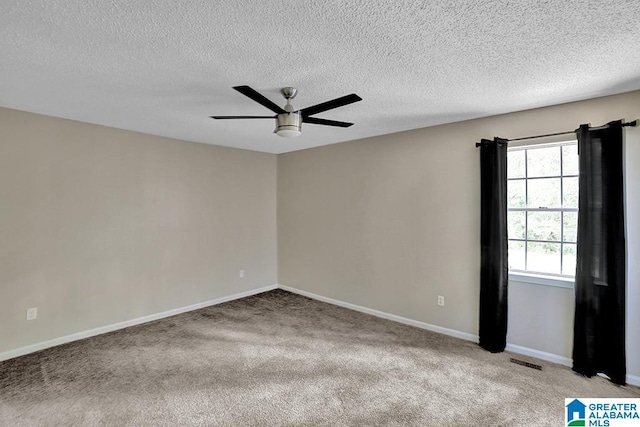 carpeted spare room with ceiling fan and a textured ceiling