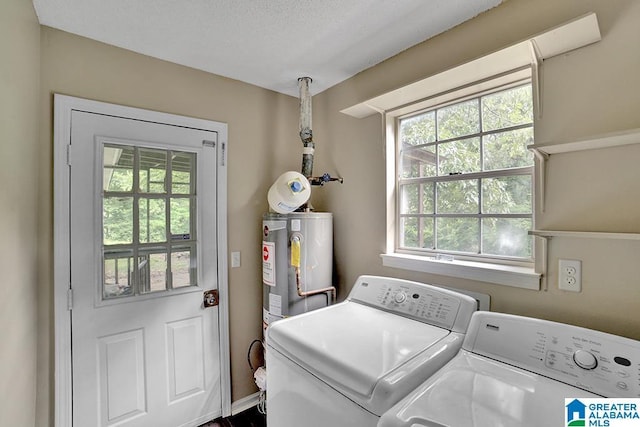 washroom featuring water heater and washing machine and clothes dryer