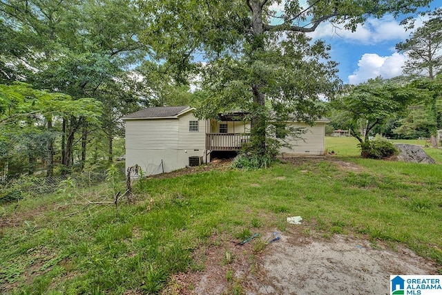 view of yard featuring a wooden deck and cooling unit