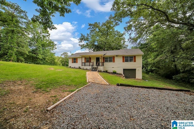 view of front of home with a porch, a front yard, and a garage