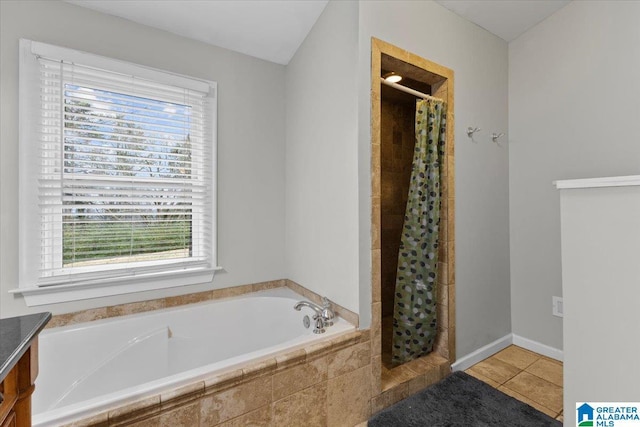 bathroom with tile patterned flooring, plus walk in shower, and vanity