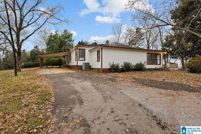 view of home's exterior featuring a carport and central air condition unit