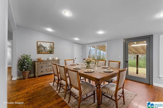 dining space with hardwood / wood-style flooring and vaulted ceiling