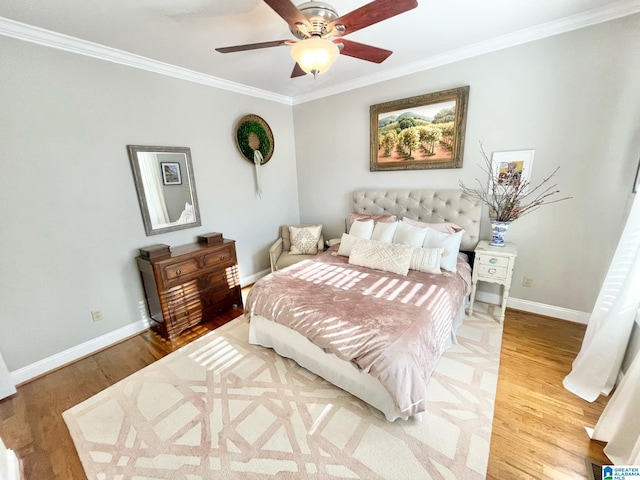 bedroom with hardwood / wood-style floors, ceiling fan, and crown molding