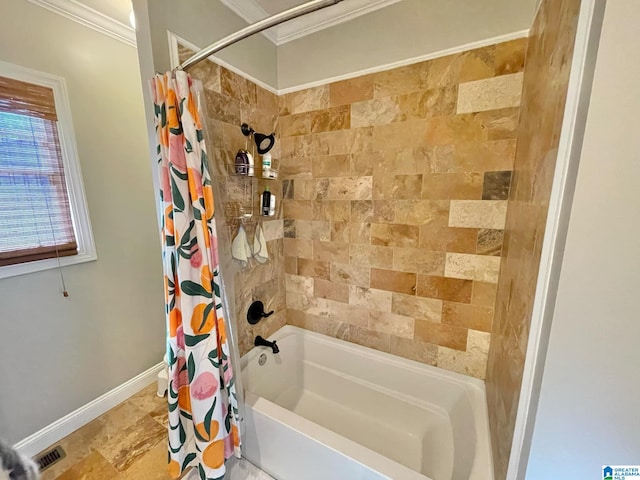 bathroom with ornamental molding and shower / tub combo