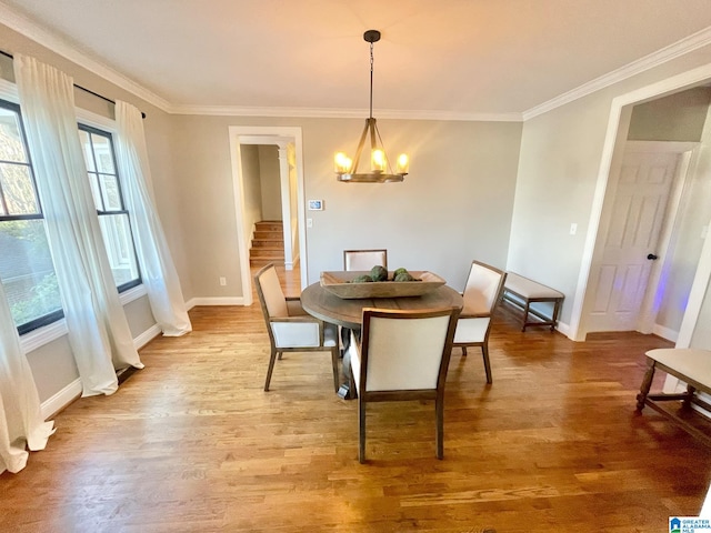 dining space featuring a notable chandelier, wood-type flooring, and crown molding