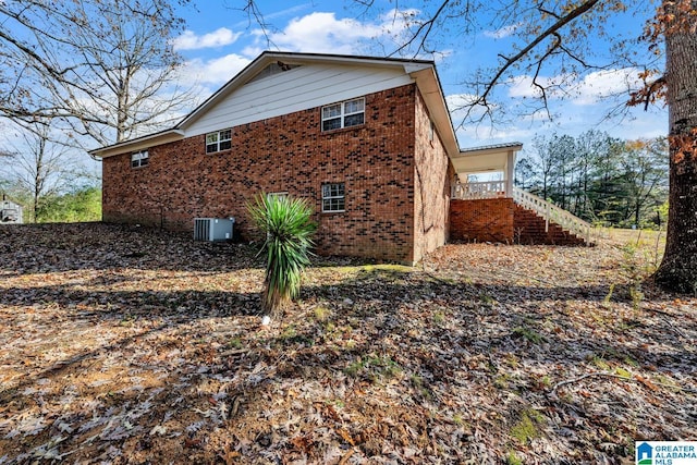 view of side of property featuring central air condition unit