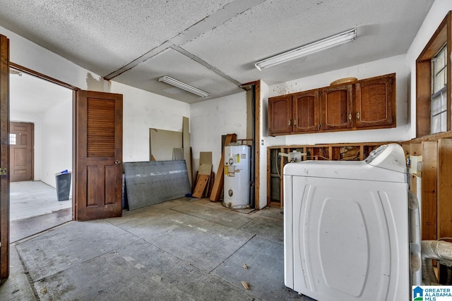 clothes washing area with a textured ceiling, washer / clothes dryer, cabinets, and gas water heater