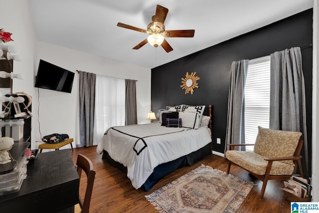 bedroom with ceiling fan and dark wood-type flooring