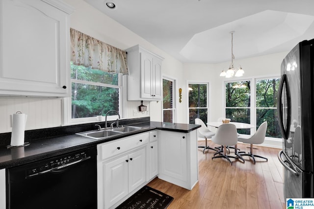 kitchen with sink, light hardwood / wood-style flooring, a chandelier, white cabinets, and black appliances