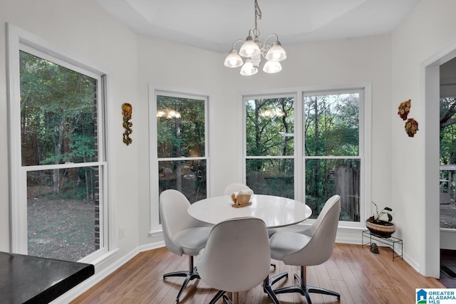 dining space with a chandelier and light wood-type flooring