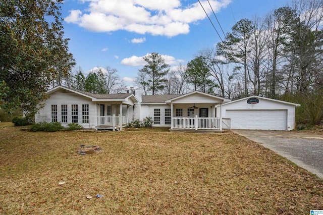 ranch-style home with an outbuilding, covered porch, and a garage