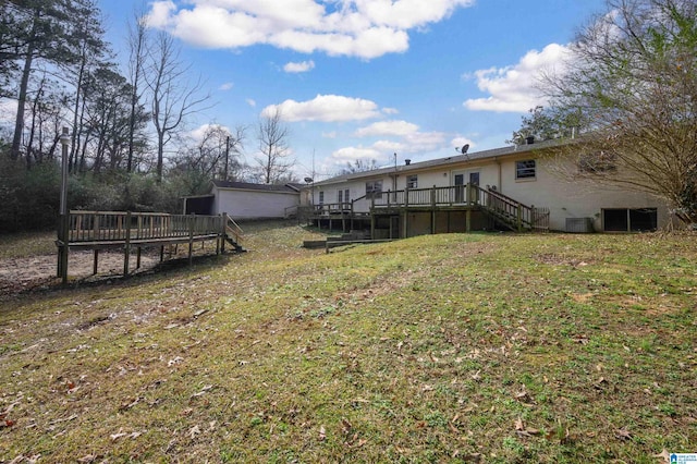 view of yard with central AC unit and a deck