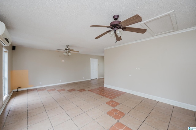 tiled empty room featuring a wall unit AC, ceiling fan, and a textured ceiling