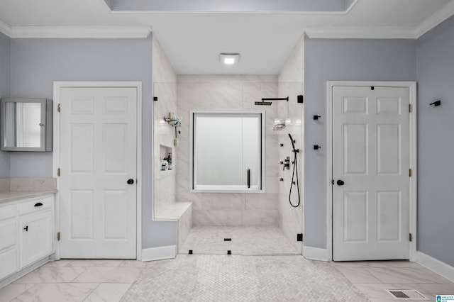 bathroom with baseboards, marble finish floor, crown molding, vanity, and a shower stall