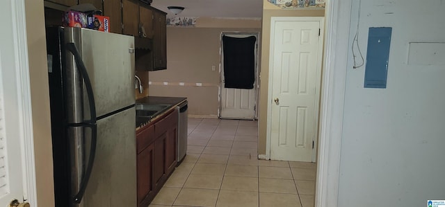 kitchen with electric panel, stainless steel appliances, and light tile patterned flooring