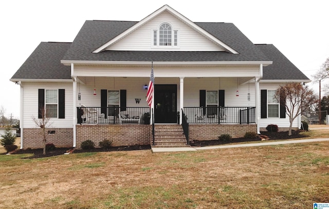 view of front of home featuring covered porch and a front yard