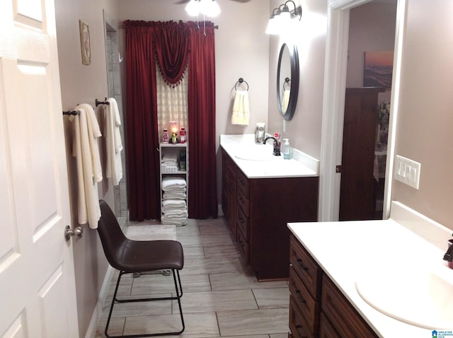 bathroom with ceiling fan and vanity