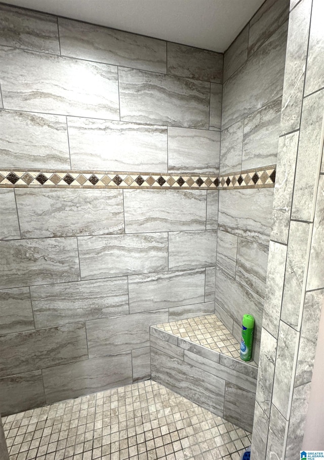 bathroom with tiled shower