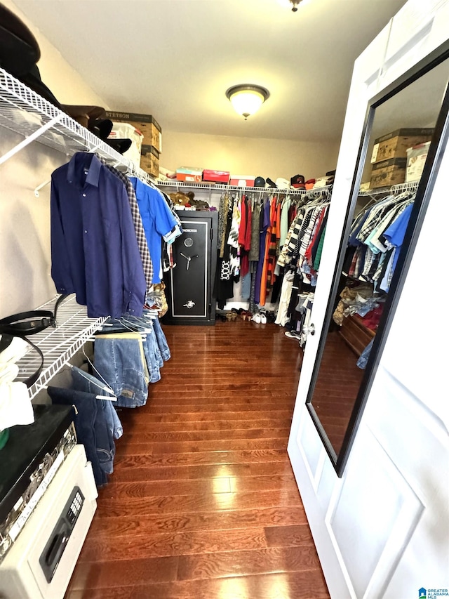 spacious closet with dark hardwood / wood-style flooring