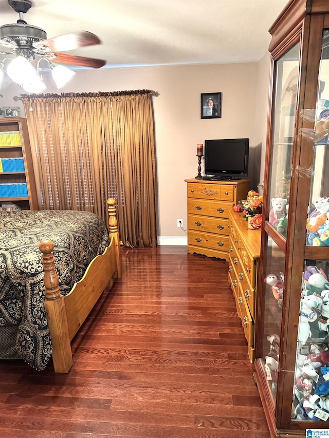 bedroom with ceiling fan and dark wood-type flooring