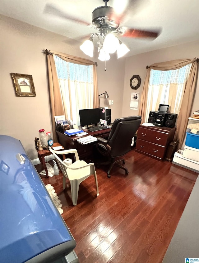 office space featuring dark hardwood / wood-style flooring, a baseboard radiator, and ceiling fan