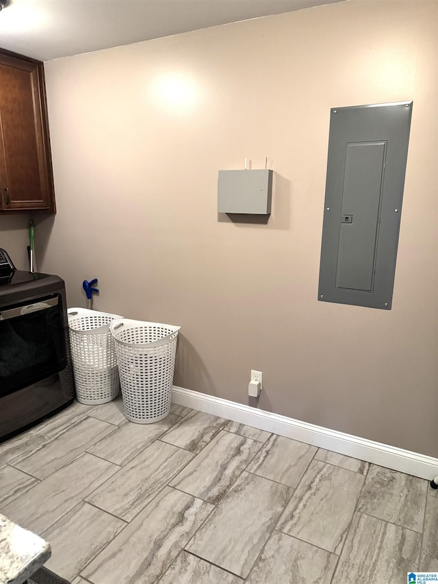 washroom featuring cabinets and electric panel