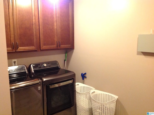 washroom with cabinets and separate washer and dryer