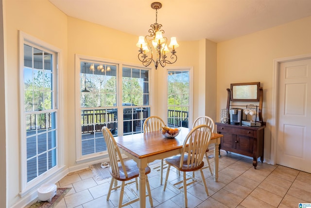 tiled dining room with an inviting chandelier