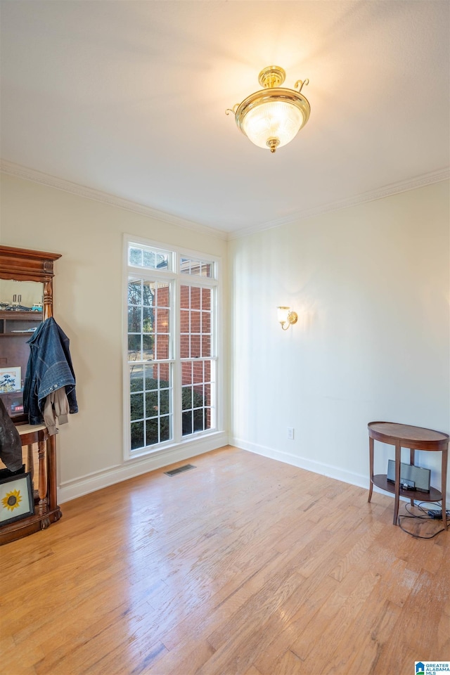 living room with light hardwood / wood-style flooring and ornamental molding